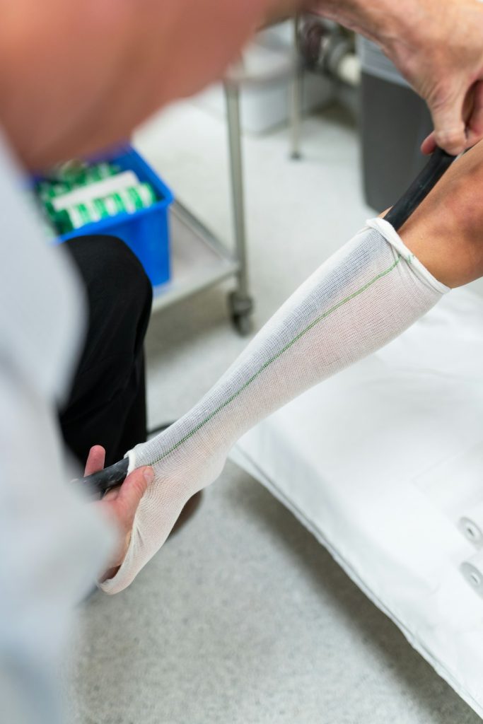 Male orthotic technician engineer measures patients leg